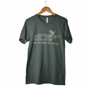 Green Tennessee Innocence Project distressed logo t-shirt on a wooden hanger